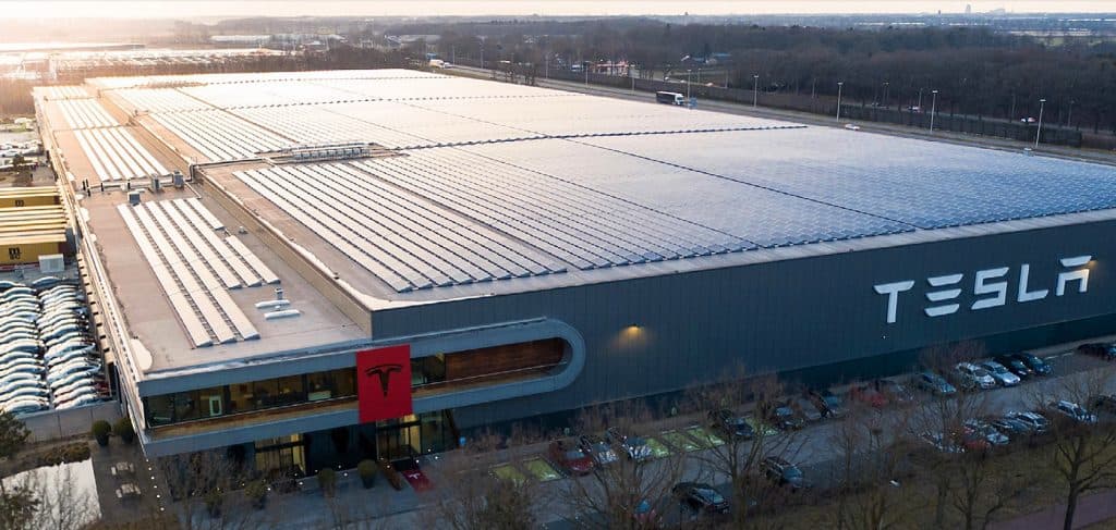 https://s3.ap-south-1.amazonaws.com/evfy.bucket1/tesla factory.jpeg